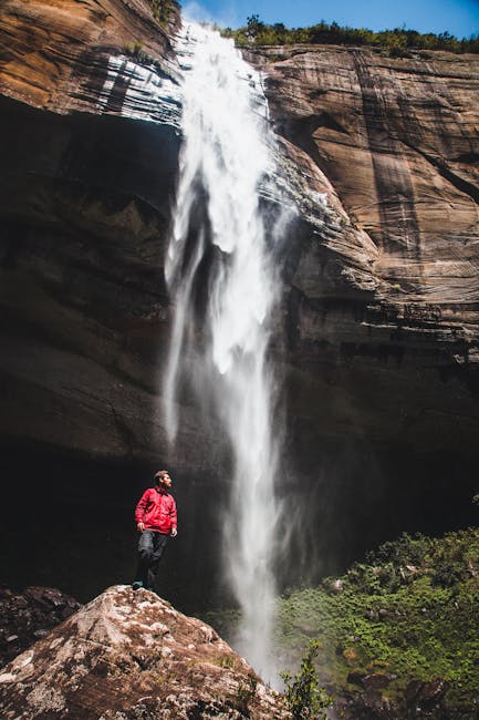 Man at high waterfall
